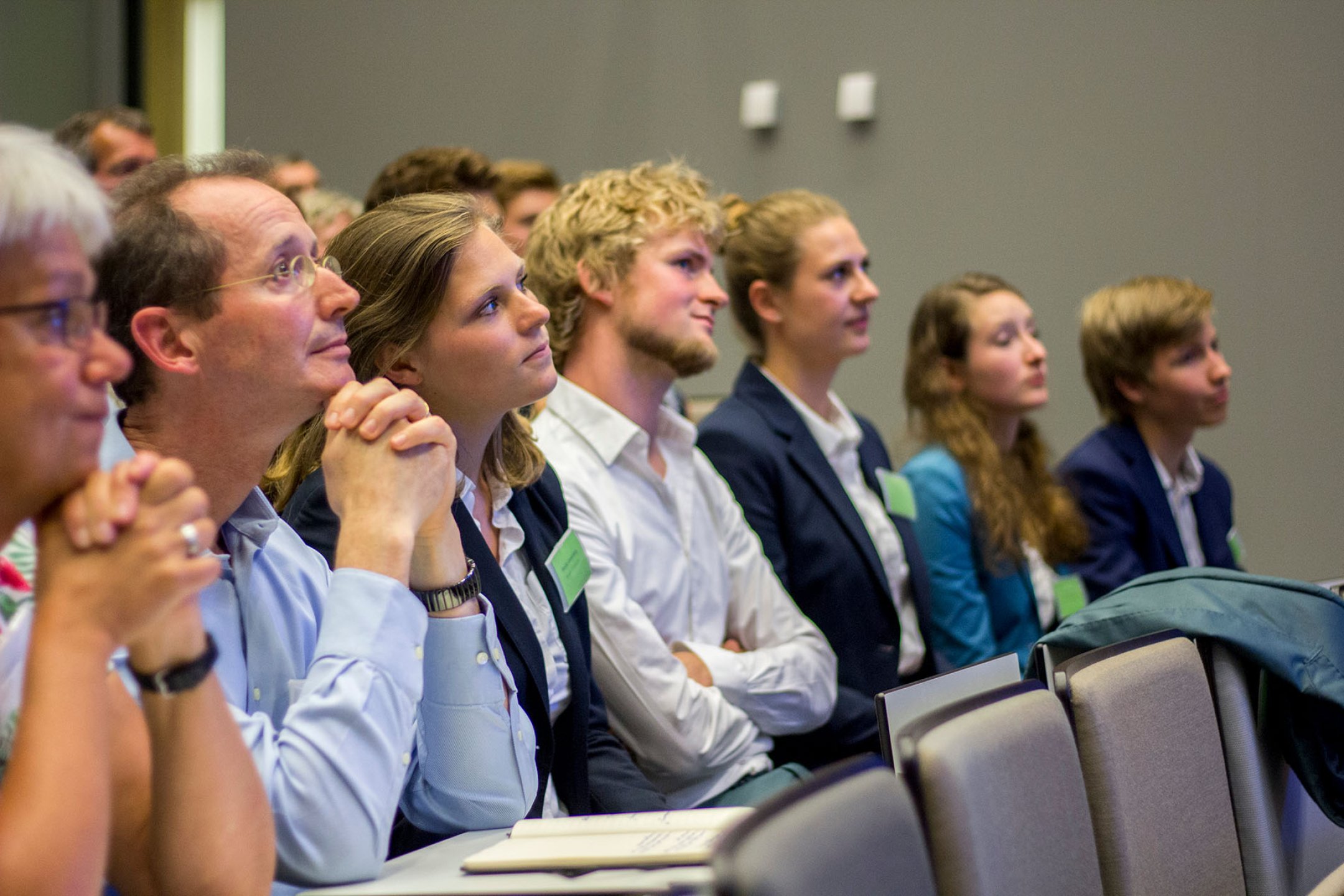Mensen luisteren aandachtig in een auditorium